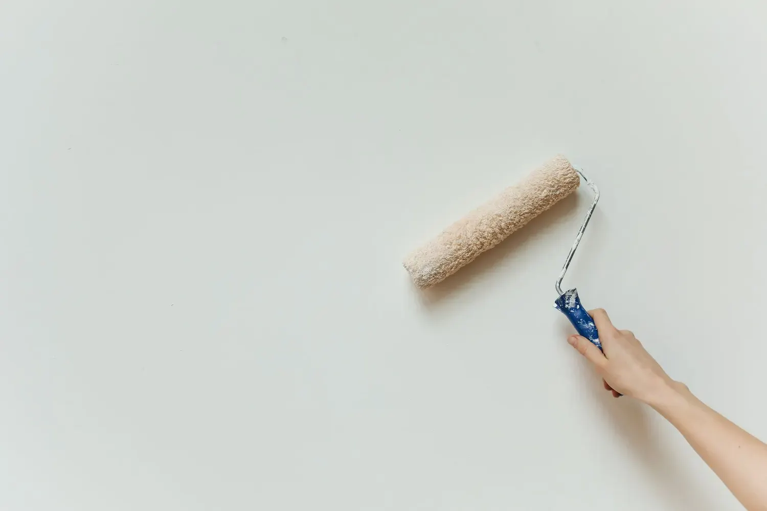 Interior painting in Marietta, GA: hand rolling fresh paint onto a wall